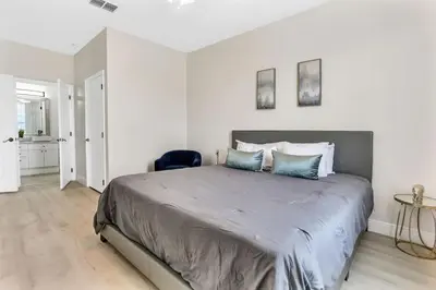 a bedroom with a large bed with blue pillows at Big Condo 3 bedrooms, Pool in Kissimmee