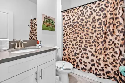 a bathroom with a leopard print shower curtain at Home 07 Bedrooms6 Baths At Storey Lake in Kissimmee