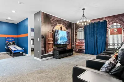 a living room with a couch and a flat screen tv at Home 07 Bedrooms6 Baths At Storey Lake in Kissimmee