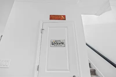 a white door with a sign on top of it at Home 07 Bedrooms6 Baths At Storey Lake in Kissimmee