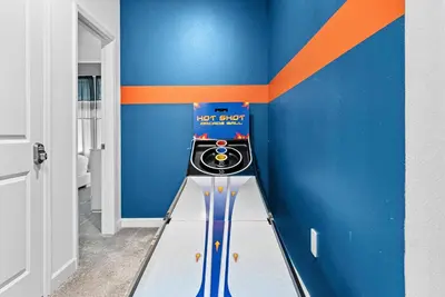 a room with a pinball machine in the corner at Home 07 Bedrooms6 Baths At Storey Lake in Kissimmee