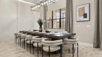a dining room with a long table and stools at Lakeside Villa with Pool BBQ Cinema & Games Room in Kissimmee