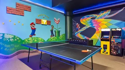 a ping pong table in a room with a mural at Lakeside Villa with Pool BBQ Cinema & Games Room in Kissimmee