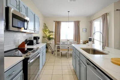 a kitchen with a sink and a counter top at 7823 BEACHFIELD KISSIMME 4BED in Orlando