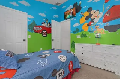 a bedroom with a mickey mouse mural on the wall at 2554 RENSHAW ST KISSIMMEE 3BEDS in Orlando