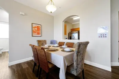 a dining room with a table and chairs at 8105 COCONUT PALM WAY UNIT 205 KISSIMMEE 3BEDS in Kissimmee