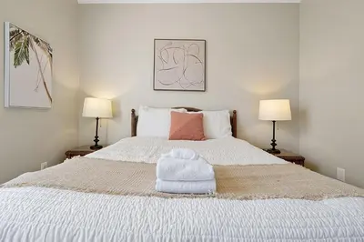 a bedroom with a white bed with towels on it at 8105 COCONUT PALM WAY UNIT 205 KISSIMMEE 3BEDS in Kissimmee