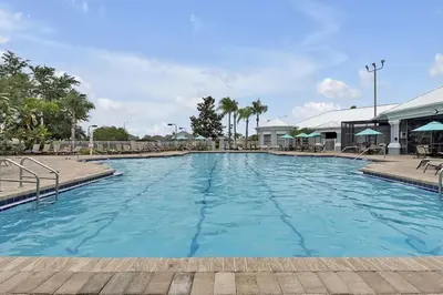 a large pool with blue water in a resort at 8105 COCONUT PALM WAY UNIT 205 KISSIMMEE 3BEDS in Kissimmee