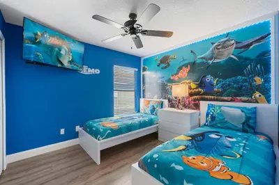 a bedroom with a blue wall with a fish mural at Emerald- 2793 in Kissimmee