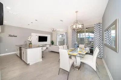 a dining room and living room with a table and chairs at Stunning Retreat Townhouse 4 Beds and 10 Mins to Disney With Pool in Kissimmee