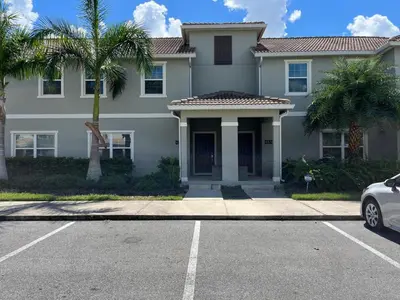 a house with a car parked in front of it at Stunning Retreat Townhouse 4 Beds and 10 Mins to Disney With Pool in Kissimmee