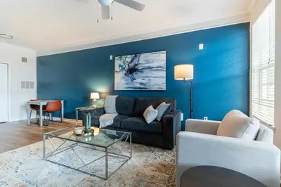 a living room with a couch and a table at Landing Beautiful 1BD Gym Pool in Orlando