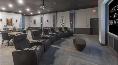 a waiting room with leather chairs and a table at Landing Beautiful 1BD Gym Pool in Orlando