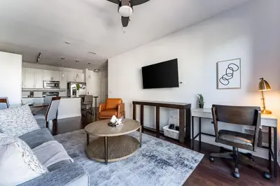 a living room with a couch and a table at Landing Stylish 1BD Rooftop Lounge Gym in Orlando