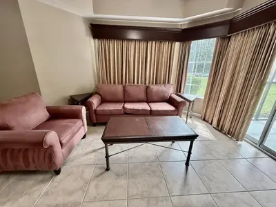 a living room with two couches and a coffee table at Entire Condo - 3Bed 2Bath- 5 mins to Disney Park in Orlando