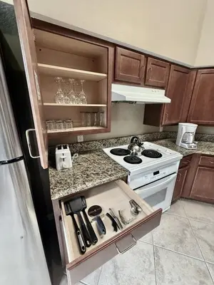 a small kitchen with a stove and a counter top at Entire Condo - 3Bed 2Bath- 5 mins to Disney Park in Orlando