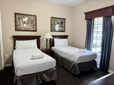 a hotel room with two beds and a window at Entire Condo - 3Bed 2Bath- 5 mins to Disney Park in Orlando