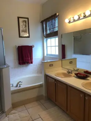 a bathroom with a tub and two sinks and a bath tub at Formosa Villa with Private Pool & 5 Miles to Disney in Orlando