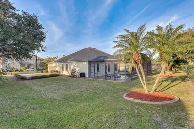a house with a palm tree in the yard at Formosa Villa with Private Pool & 5 Miles to Disney in Orlando