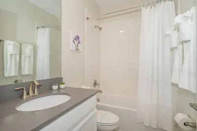 a bathroom with a sink and a toilet and a shower at Luxo com 6 Quartos e Piscina! – Storey Lake in Kissimmee