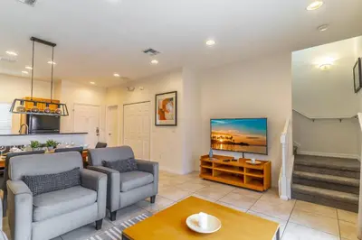 a living room with two chairs and a table at 3027 Encantada in Kissimmee