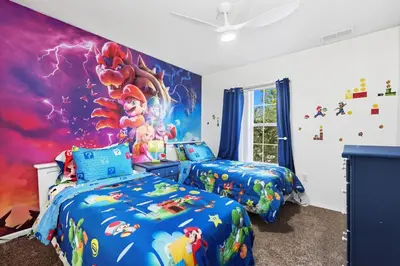 two beds in a bedroom with a disney mural at Private Hot Tub Terra Verde Resort Pool Themed Rooms in Kissimmee