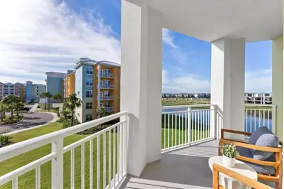 a balcony with a view of the ocean and condos at 8070-304 Luxury 2BR Apt Kissimmee Orlando Disney in Orlando