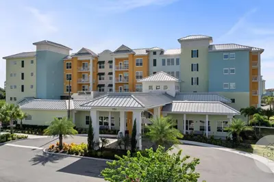 a large apartment building with a parking lot at 8070-304 Luxury 2BR Apt Kissimmee Orlando Disney in Orlando