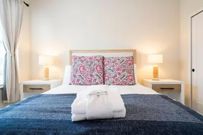 a bedroom with a large bed with two lamps at Beautiful 4-bedroom House with Splash Pool in Orlando