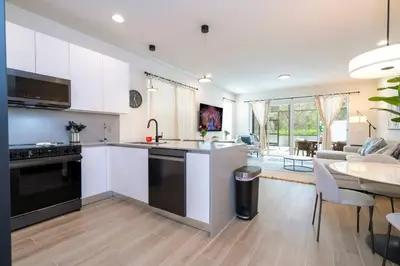 an open kitchen and living room with a dining room at Beautiful 4-bedroom House with Splash Pool in Orlando