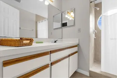 a white bathroom with a sink and a shower at Great for Families 1-4 Kids! Near Disney, Universal, Shopping, Dining in Kissimmee