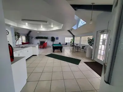 a kitchen and living room with a pool table at Great for Families 1-4 Kids! Near Disney, Universal, Shopping, Dining in Kissimmee