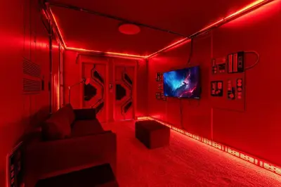 a red room with a couch and a tv at 5 Mi to Disney 4 Master Bed Rooms and Themed in Orlando