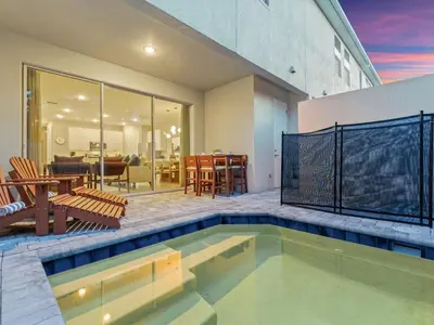 a house with a swimming pool and a patio at 5 Mi to Disney 4 Master Bed Rooms and Themed in Orlando