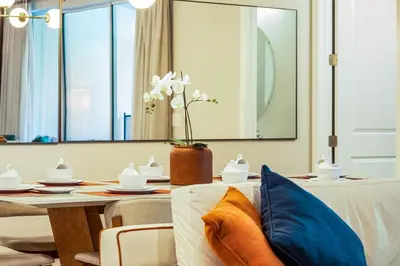 a dining room with a table with blue and orange pillows at 5 Mi to Disney 4 Master Bed Rooms and Themed in Orlando