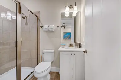a bathroom with a toilet and a sink and a shower at Lush Garden Oasis Cottage Near Disney With Margaritaville Resort And Island H2O Waterpark Access - 8016Ff in Orlando