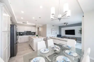 a kitchen and dining room with a glass table at Resort Condo 10 Min to Disney in Kissimmee
