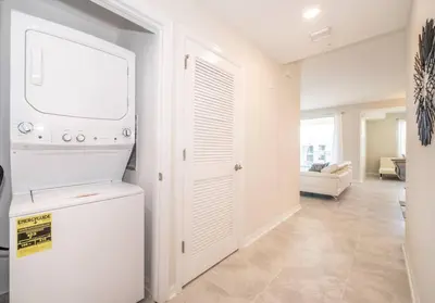 a kitchen with a washer and dryer in a room at Resort Condo 10 Min to Disney in Kissimmee