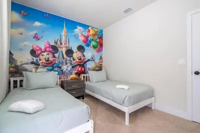 a bedroom with two beds and a disney mural at Stylish Property with Private Pool in Orlando