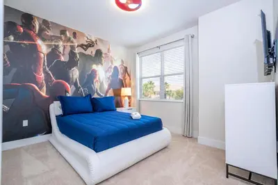 a bedroom with a large painting on the wall at Stylish Property with Private Pool in Orlando