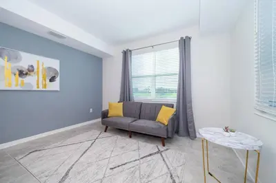 a living room with a couch and a window at Amazing Condo Getaway in Kissimmee
