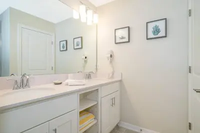 a bathroom with two sinks and a large mirror at Amazing Condo Getaway in Kissimmee