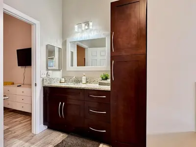 a bathroom with a sink and a mirror at Modern 4BR 2BA with pool in gated community in Kissimmee