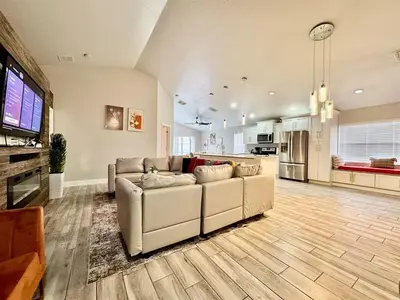 a living room with a couch and a kitchen at Modern 4BR 2BA with pool in gated community in Kissimmee