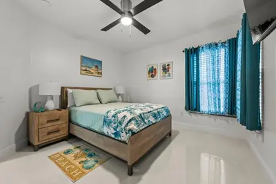 a bedroom with a bed and a ceiling fan at Luxury Disney Retreat in Kissimmee