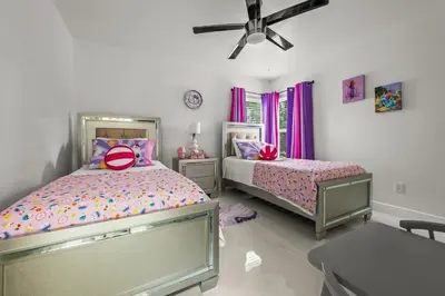 a bedroom with two beds and a ceiling fan at Luxury Disney Retreat in Kissimmee
