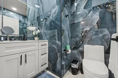 a bathroom with a shower and a white toilet at Luxury Disney Retreat in Kissimmee