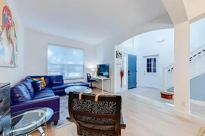a living room with a blue couch and a table at EIR2706 - 7B Lakefront Resort 8 min to Disney in Kissimmee