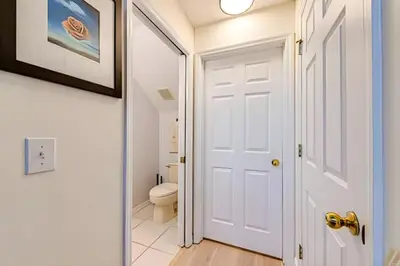 a bathroom with a white door and a toilet at EIR2706 - 7B Lakefront Resort 8 min to Disney in Kissimmee