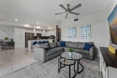 a living room with a couch and a ceiling fan at Spacious 2BR Mickey Bedroom Lake View in Kissimmee